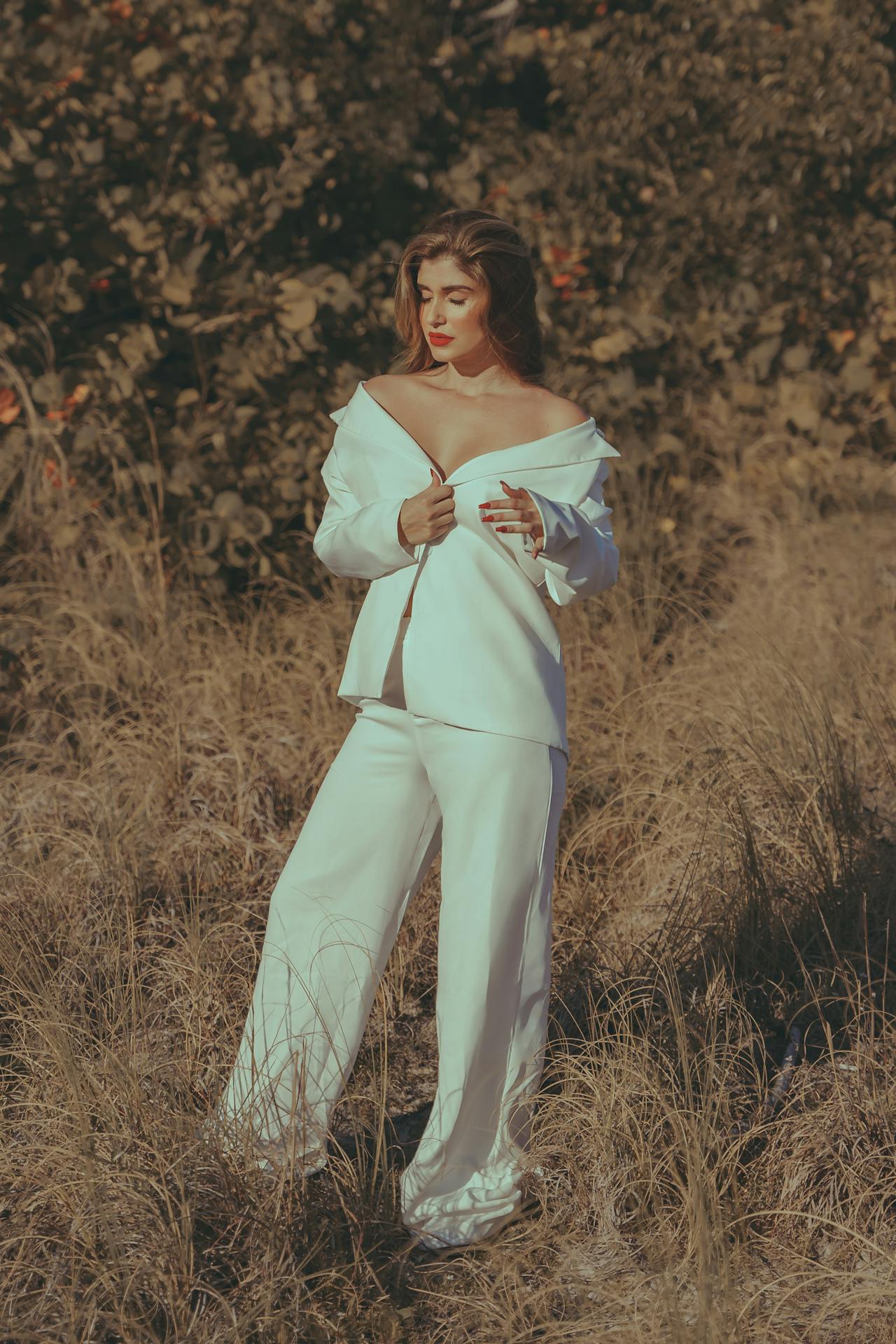 American woman wearing minimalist luxury outfit from TAHMINA womenswear collection, standing in natural light